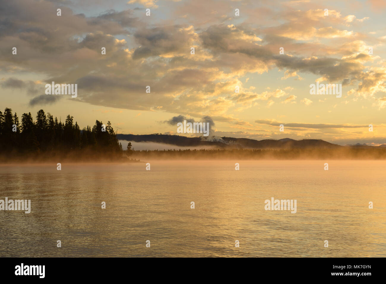 Morning Misty Lake - Colorful clouds and morning fog over Yellowstone Lake, Yellowstone National Park, Wyoming, USA. Stock Photo