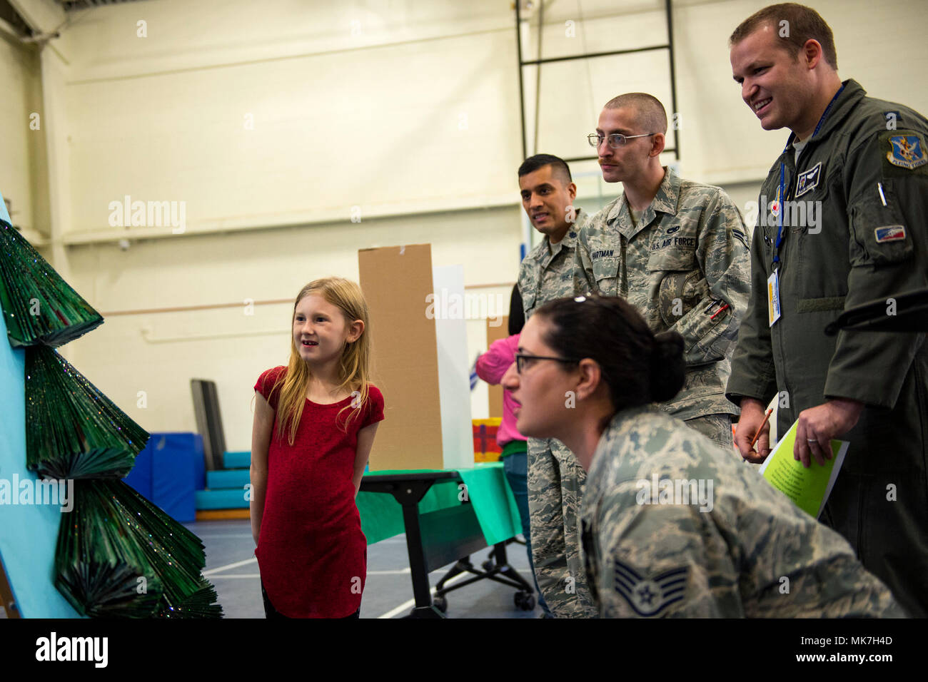 A recycled project participant shows the judges her project during the