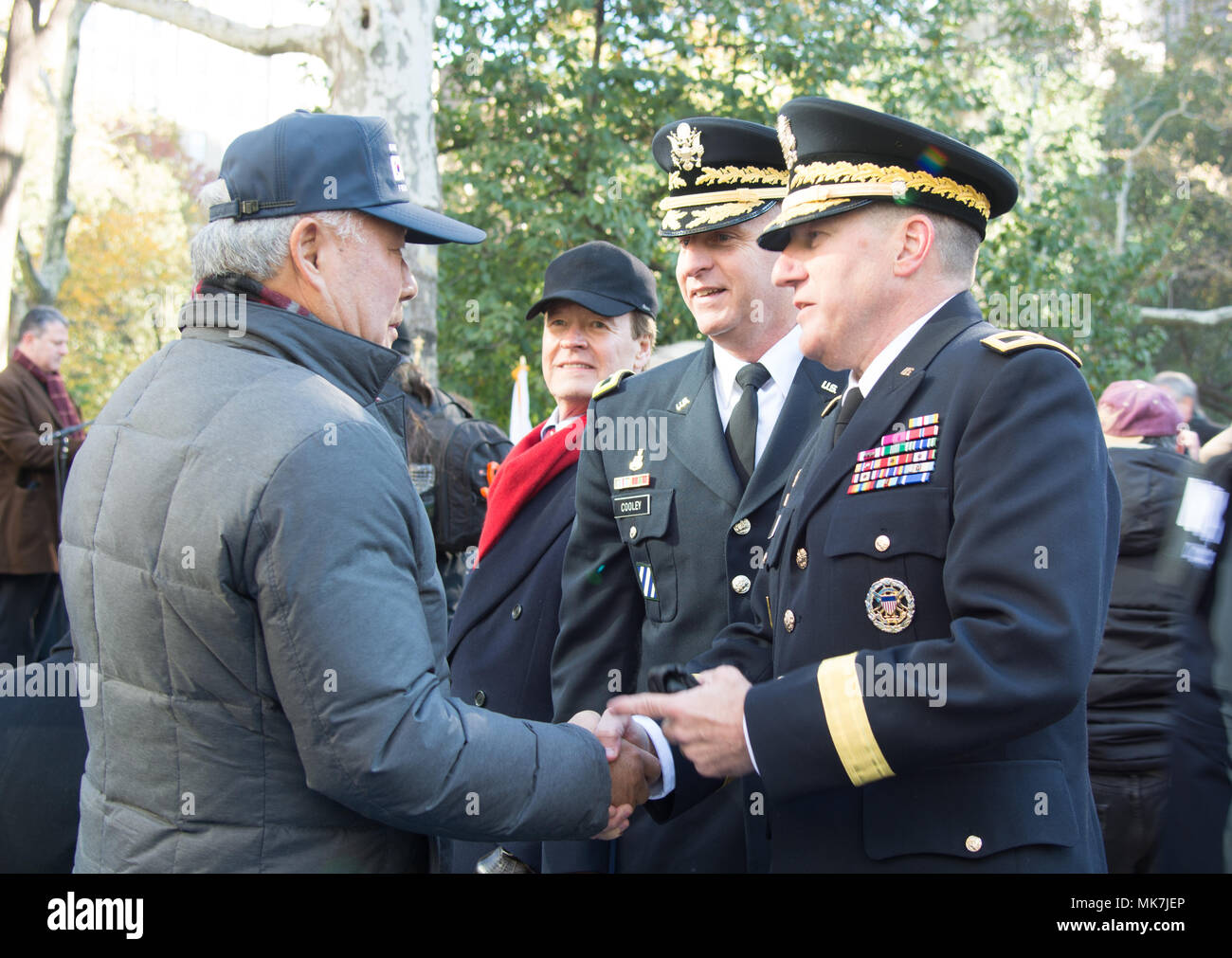 (Center) Brig. Gen. Robert S. Cooley, commander of the 353d Civil Affairs Command, and (Right) Maj. Gen. Mark W. Palzer, commander of the 79th Theater Sustainment Command, talk with a veteran (Left) at the opening wreath laying ceremony of the NYC Veterans Day Parade, November 11, 2017. (U.S. Army Reserve Photo by Maj. Addie Leonhardt, 80th Training Command) Stock Photo