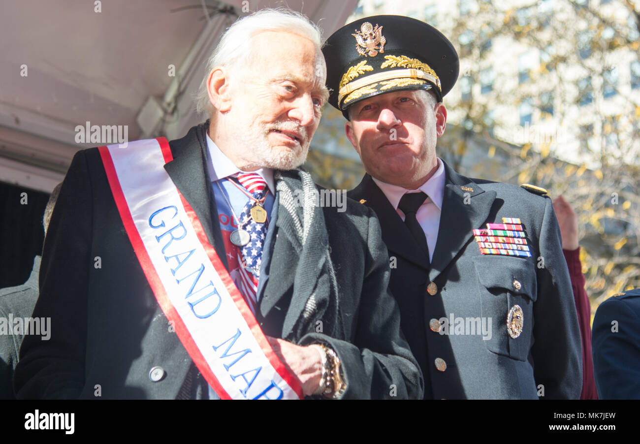 (Left) Buzz Aldrin, Grand Marshall of this year's NYC Veterans Day Parade, and (Right) Maj. Gen. Mark W. Palzer, commander of the 79th Theater Sustainment Command, observe the parade from the review stand, November 11, 2017. (U.S. Army Reserve Photo by Maj. Addie Leonhardt, 80th Training Command) Stock Photo