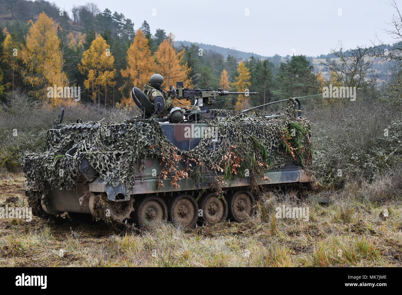 Lithuanian soldiers maneuver their tracked armored vehicle during Exercise Allied Spirit VII at the 7th Army Training Command’s Hohenfels Training Area, Germany, Nov. 16, 2017. Approximately 4,050 service members from 13 nations are participating in the exercise from Oct. 30 to Nov. 22, 2017. Allied Spirit is a U.S. Army Europe-directed, 7ATC-conducted multinational exercise series designed to develop and enhance NATO and key partner’s interoperability and readiness. (U.S. Army photo by Gertrud Zach) Stock Photo
