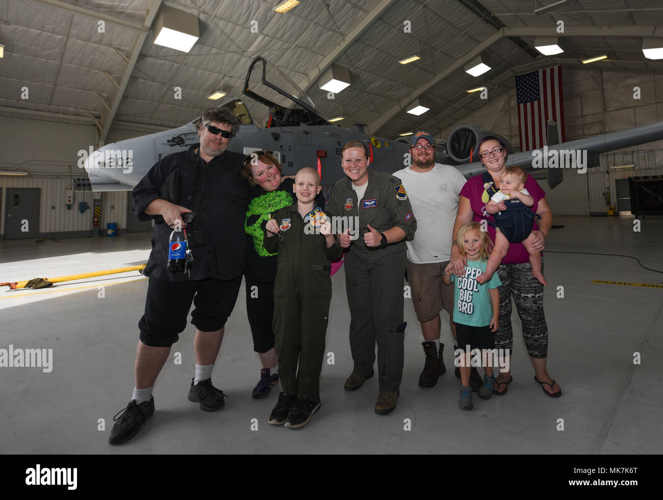 George Mitchell, Davis-Monthan Air Force Base’s Pilot for a Day, poses in front of an A-10C Thunderbolt II with his family and Capt. Nikki Yogi, 354th Fighter Squadron pilot, at D-M AFB, Ariz., Nov. 6, 2017. Davis-Monthan’s Pilot for a Day program invites children with serious or chronic health conditions to be a guest of one of D-M’s flying squadrons for a day. (U.S. Air Force photo by Airman 1st Class Frankie D. Moore) Stock Photo