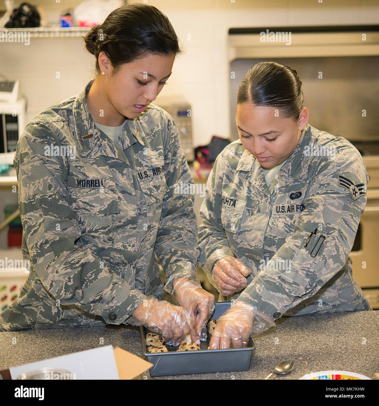 2nd Lt. Natsuko Worrell (left), a 71st Force Support Squadron military personnel program manager, and Senior Airman Jayonna Huhta, a 71st Force Support Squadron career development technician, prepare cookies Nov. 9, 2017, in the Community Activity Center on Vance Air Force Base, Oklahoma. This is part of Operation Cookie Cutter where care packages are sent to members of Team Vance who are deployed. (U.S. Air Force photo by Airman 1st Class Taylor Crul) Stock Photo