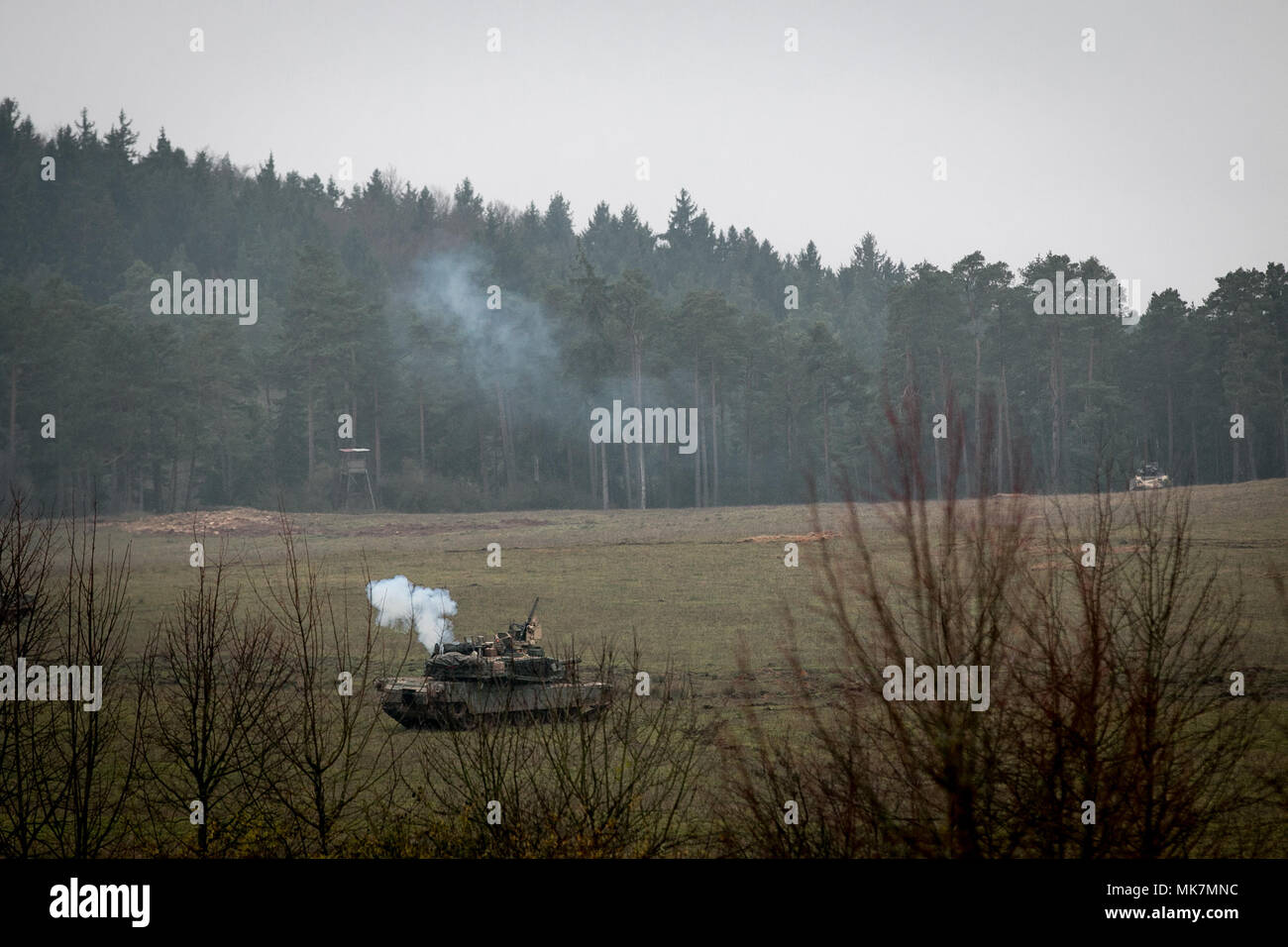 Two M-1 Abrams tanks fire simulated rounds at one another during a Allied Spirit VII training exercise firefight in Grafenwoehr, Germany Nov. 17, 2017. Approximately 3,700 service members from 13 nations gathered in 7th Army Training Command’s Hohenfels Training Area in southeastern Germany to participate in the seventh iteration of Allied Spirit, which is scheduled for Oct. 30 - Nov. 22, 2017. (U.S. Army photo by Spc. Dustin D. Biven / 22nd Mobile Public Affairs Detachment) Stock Photo