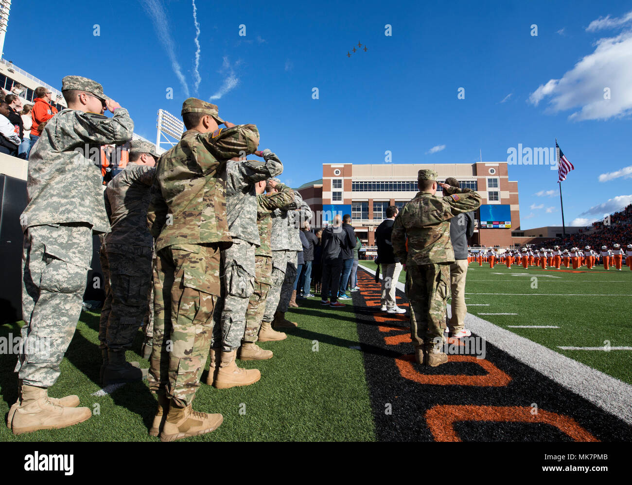 Members of the Army and Air Force ROTC Detachments at Oklahoma State University salute the American Flag during the National Anthem Nov. 18, 2017, at Boone Pickens Stadium, Oklahoma State University, Stillwater, Oklahoma. The Reserve Officers’ Training Corps program was formally created in 1916 and produces almost 30 percent of miltary officers each year. (U.S. Air Force photo by Airman Zachary Heal) Stock Photo