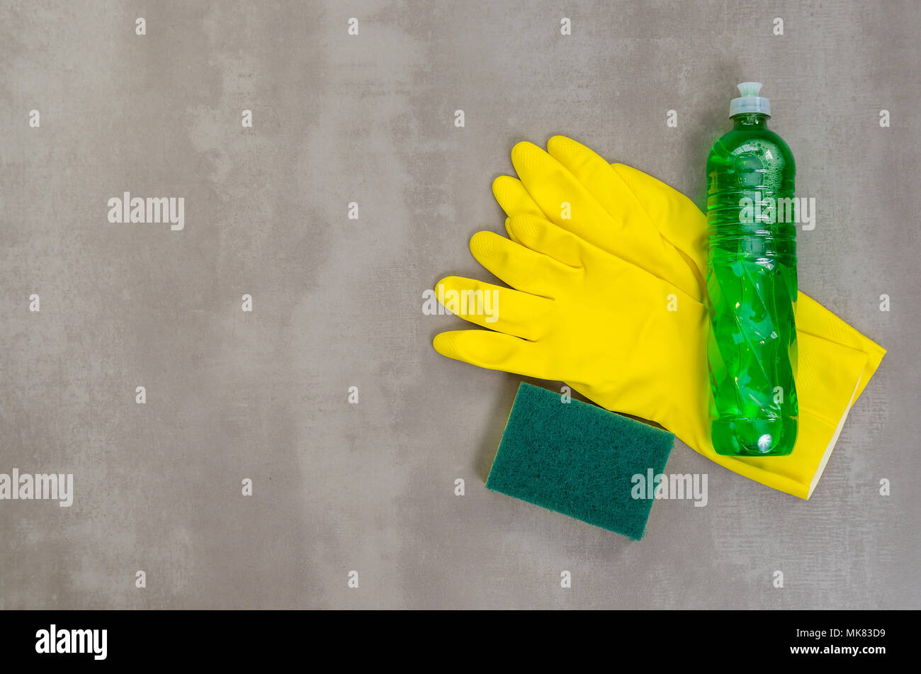 Great concept of cleaning, various products used in cleaning on gray background. Stock Photo