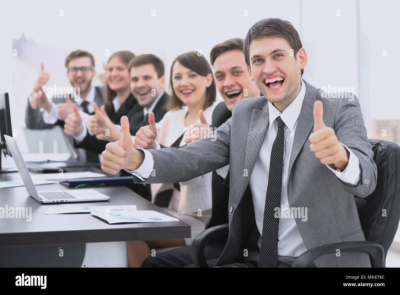 successful business team showing thumbs up Stock Photo - Alamy