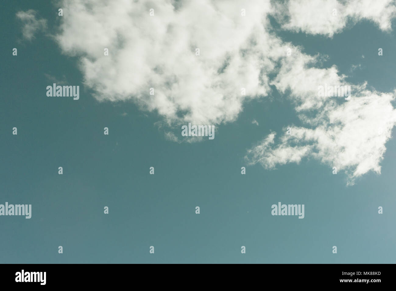 Pale blue sky with light clouds blurred, background. Heavenly landscape