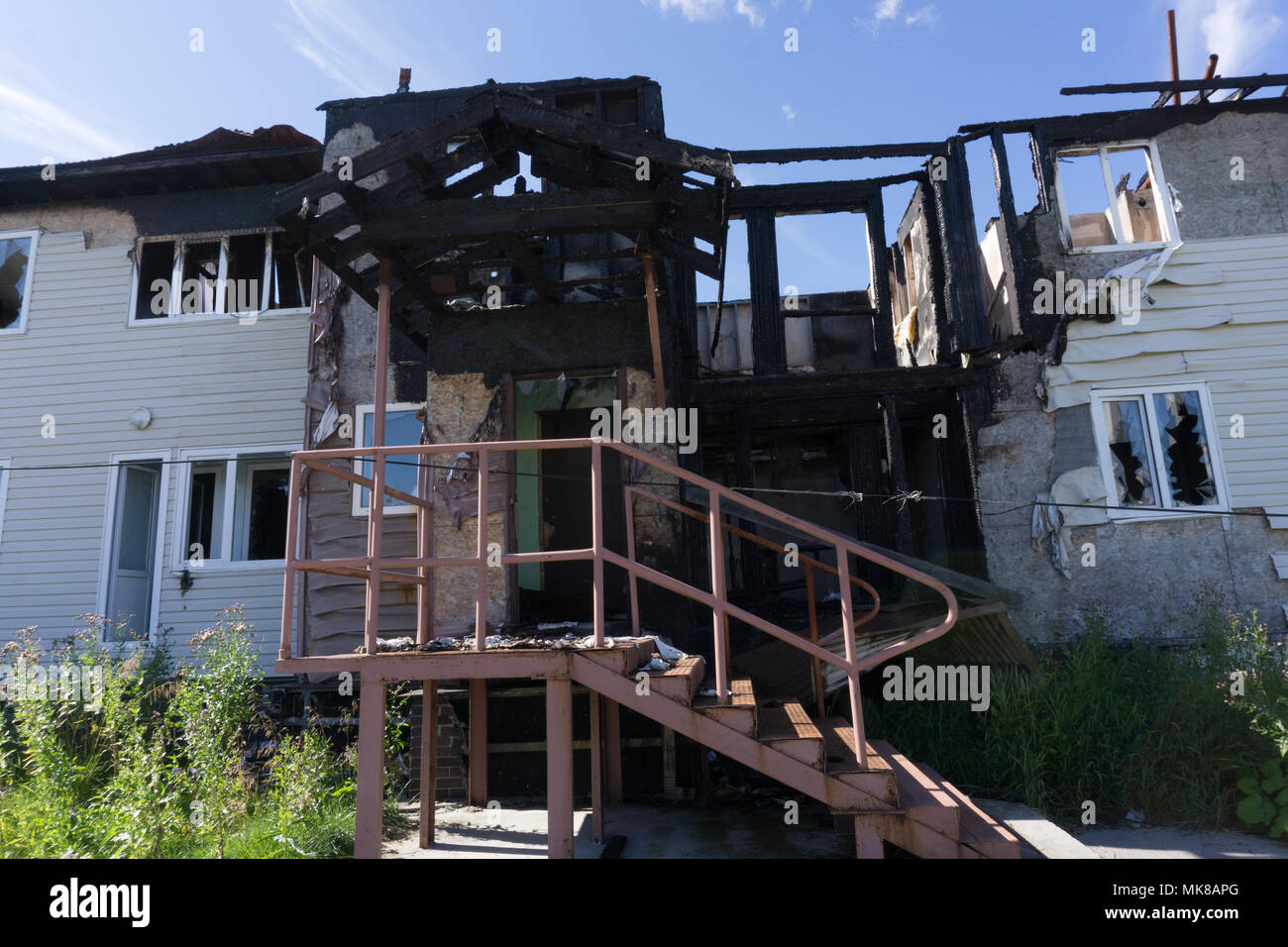 Rescuers firefighters extinguish a fire on the roof. The building after ...
