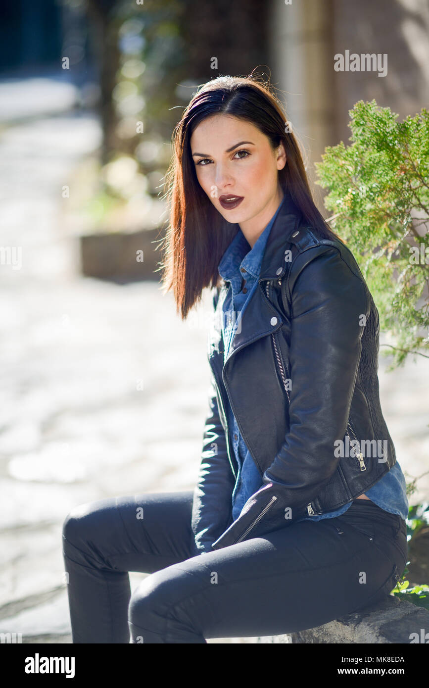 Beautiful young woman, model of fashion, in urban background. Girl wearing  leather clothes Stock Photo - Alamy