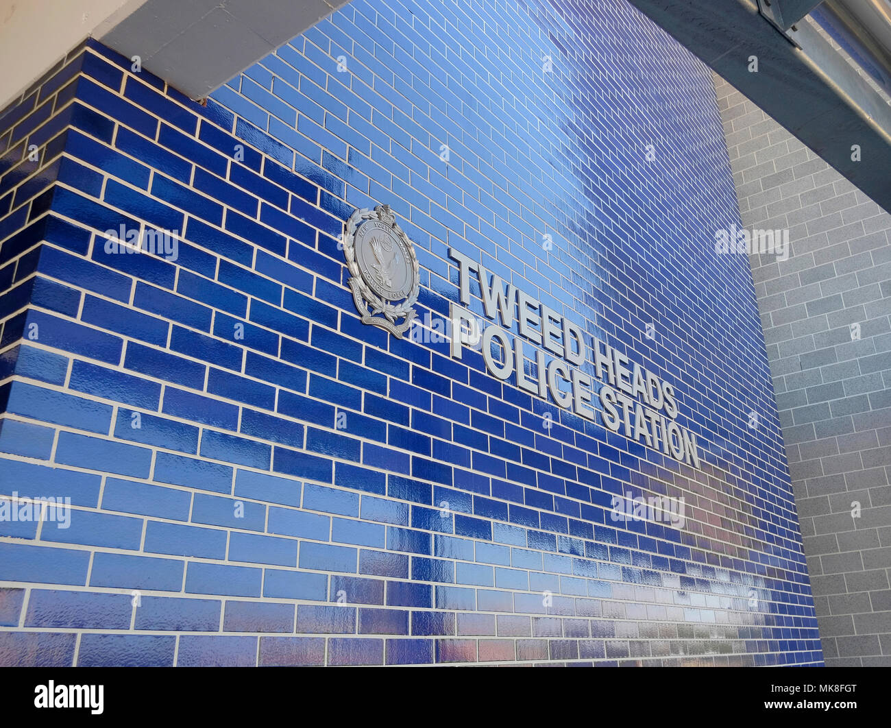 front of new Tweed Heads Police Station including sign on tiled wall Stock Photo