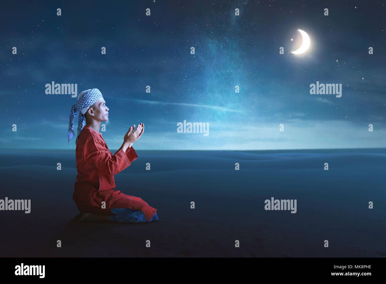 Religious asian muslim man pray to god with night scene background Stock Photo