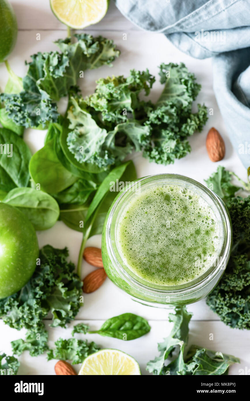 Smoothie detox with green fruits, vegetables, spinach and kale on white