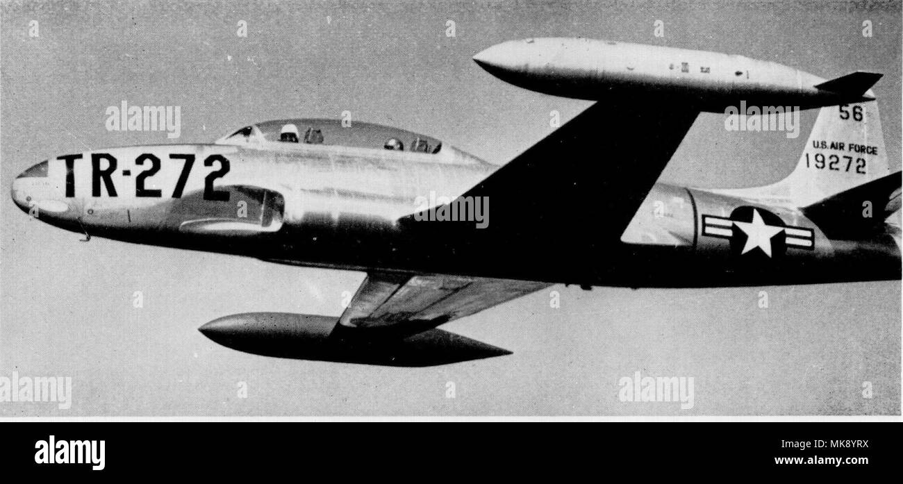 A T-33A Shooting Star shown in-flight in standard training configuration with wingtip tanks wearing natural-metal and early training command markings. The ‘TR-272’ indicates this is a training aircraft and uses the last three numbers of the serial-272- to indicated which aircraft it is. These large markings were quite useful in allowing quick identification of particular aircraft on a parking ramp filled with dozens of the same exact aircraft type with small serial numbers applied to the tail. (Courtesy photo/Tinker History Office) Stock Photo