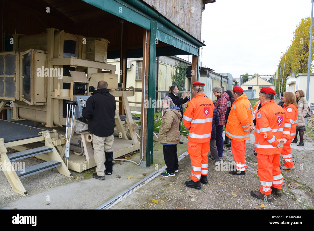 Ivano Trevisanutto, chief, Training Support Center Italy, shows the Mine Resistant Ambush Protected (MRAP), to a delegation from “Associazione Il Nuovo Ponte” and Sovereign Military Order, during a visit to Caserma Ederle Nov. 28, 2017. Associazione Il Nuovo Ponte is a social solidarity cooperative that since 1984 runs Social-Health Services for people with disabilities. (U.S. Army photo by Paolo Bovo) Stock Photo