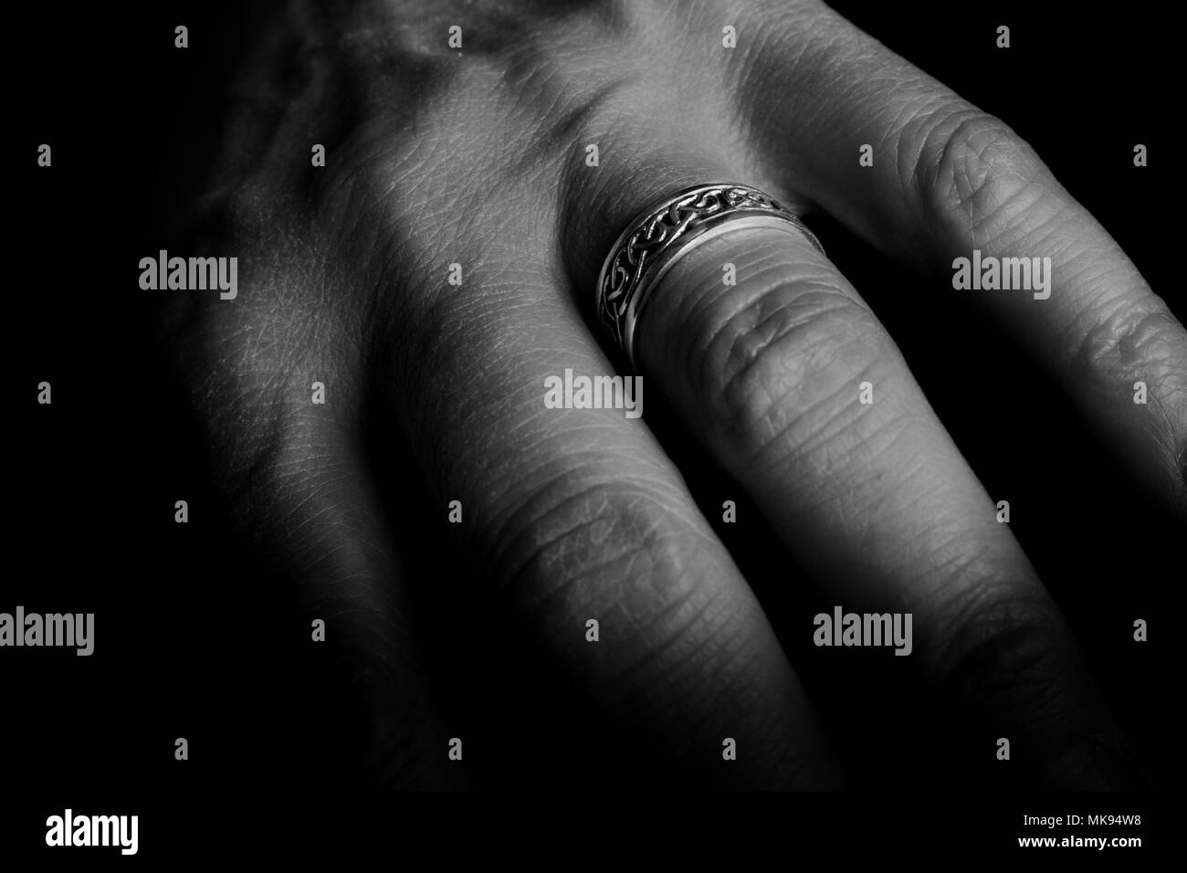 Celtic ring on finger Stock Photo