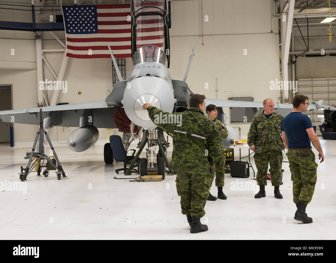 The Royal Canadian Air Force from Canadian Forces Base Cold Lake, Alberta,  park a CF-188 Hornet in a hangar at Gowen Field to fix the landing gear on  the aircraft Nov. 29,