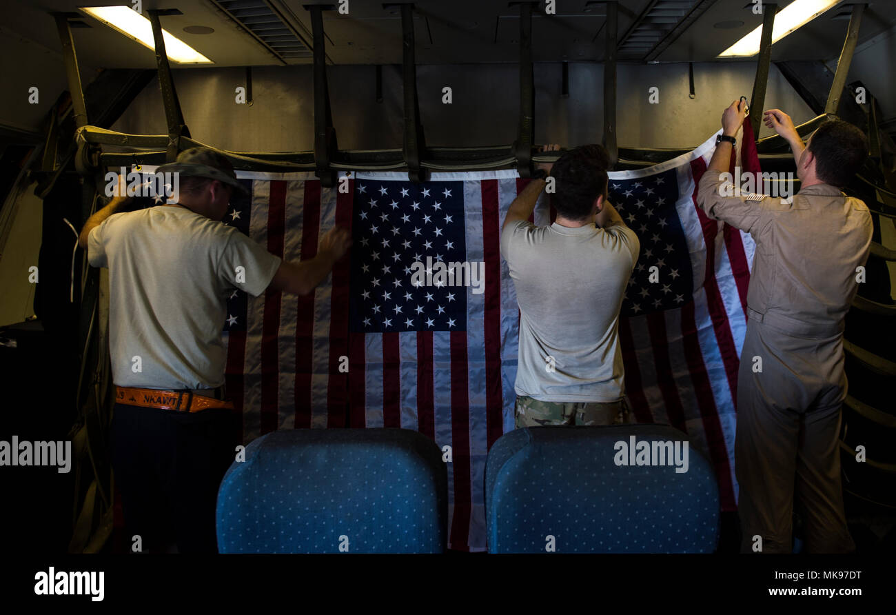A U.S. Air Force KC10 Extender aircrew hangs flags in the cabin of the