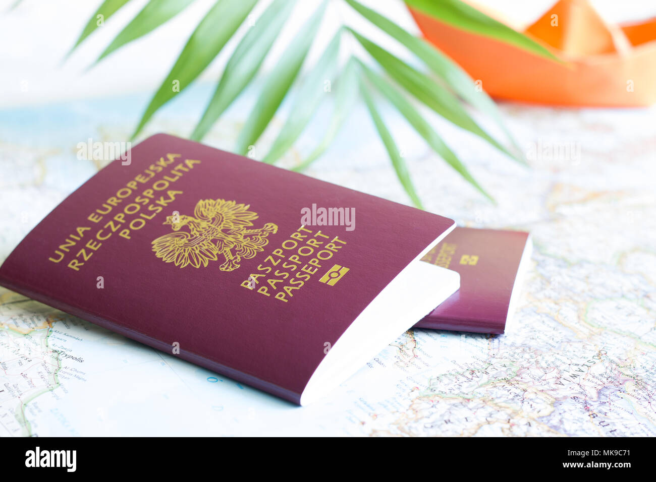 Polish passport and holiday travel vacation concept with map and paper boat Stock Photo