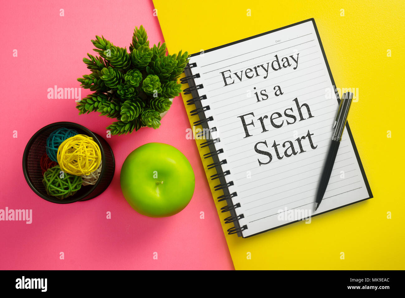 Everyday is a fresh start. Inspirational quote on notebook with pen