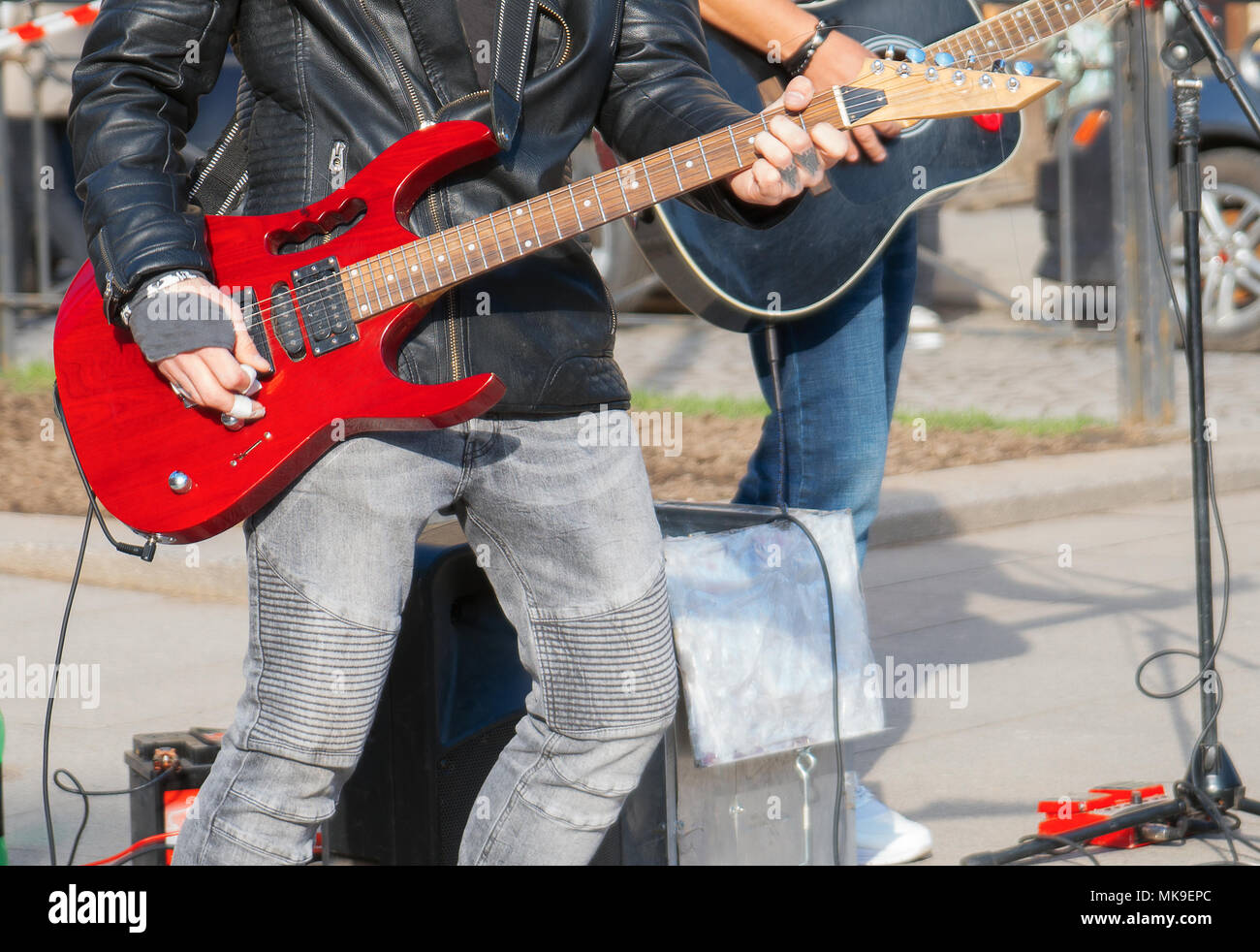 Street musicians playing on guitars. Unrecognizable persons. Stock Photo