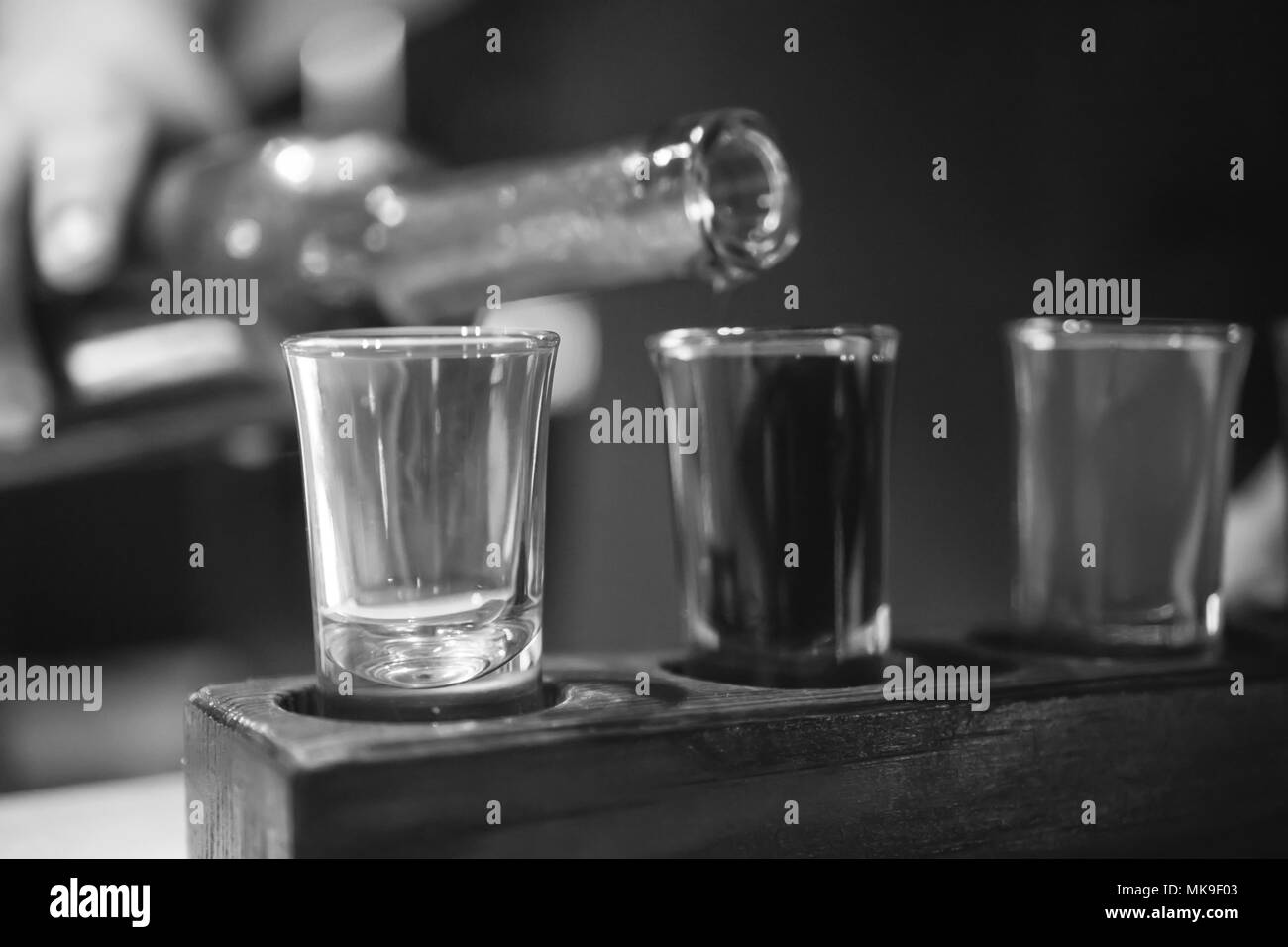 Shot glasses with liquor in the bar. Black and white Stock Photo Alamy