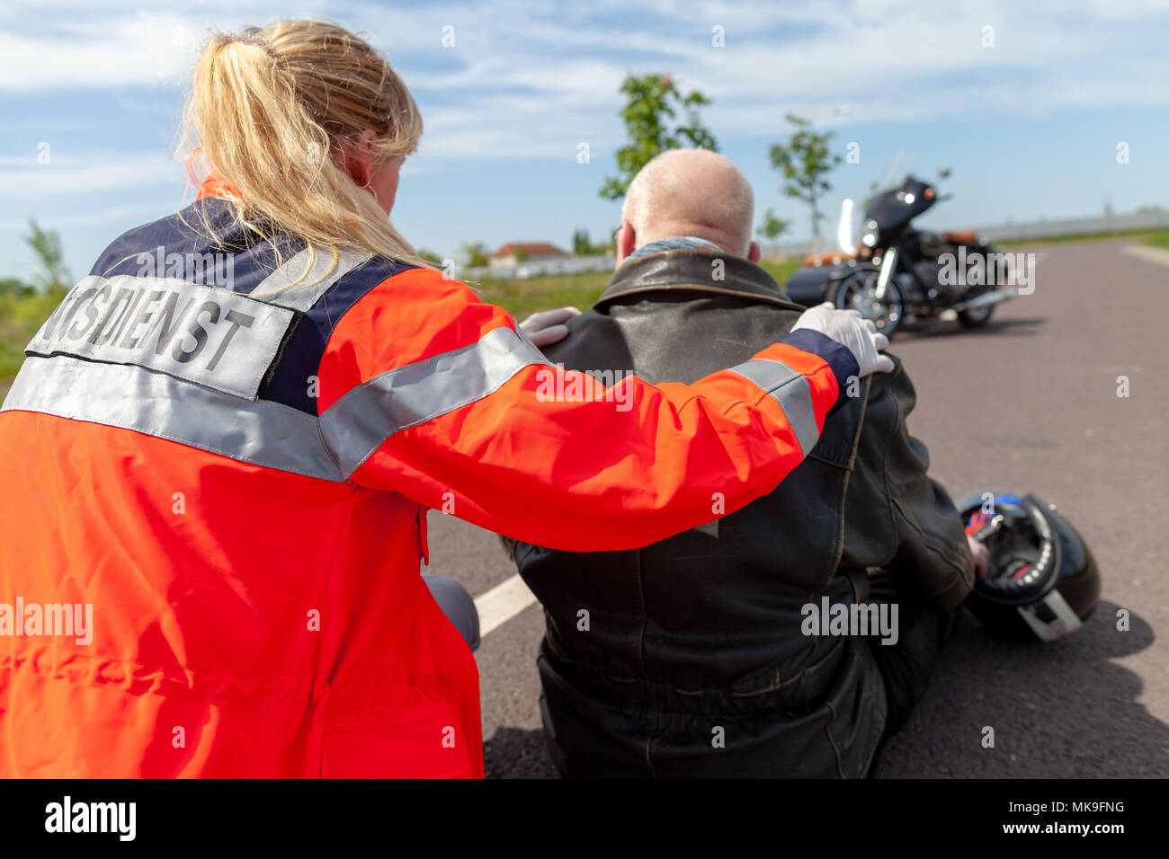 A german paramedic helps an injured motorcyclist rettungsdienst is the
