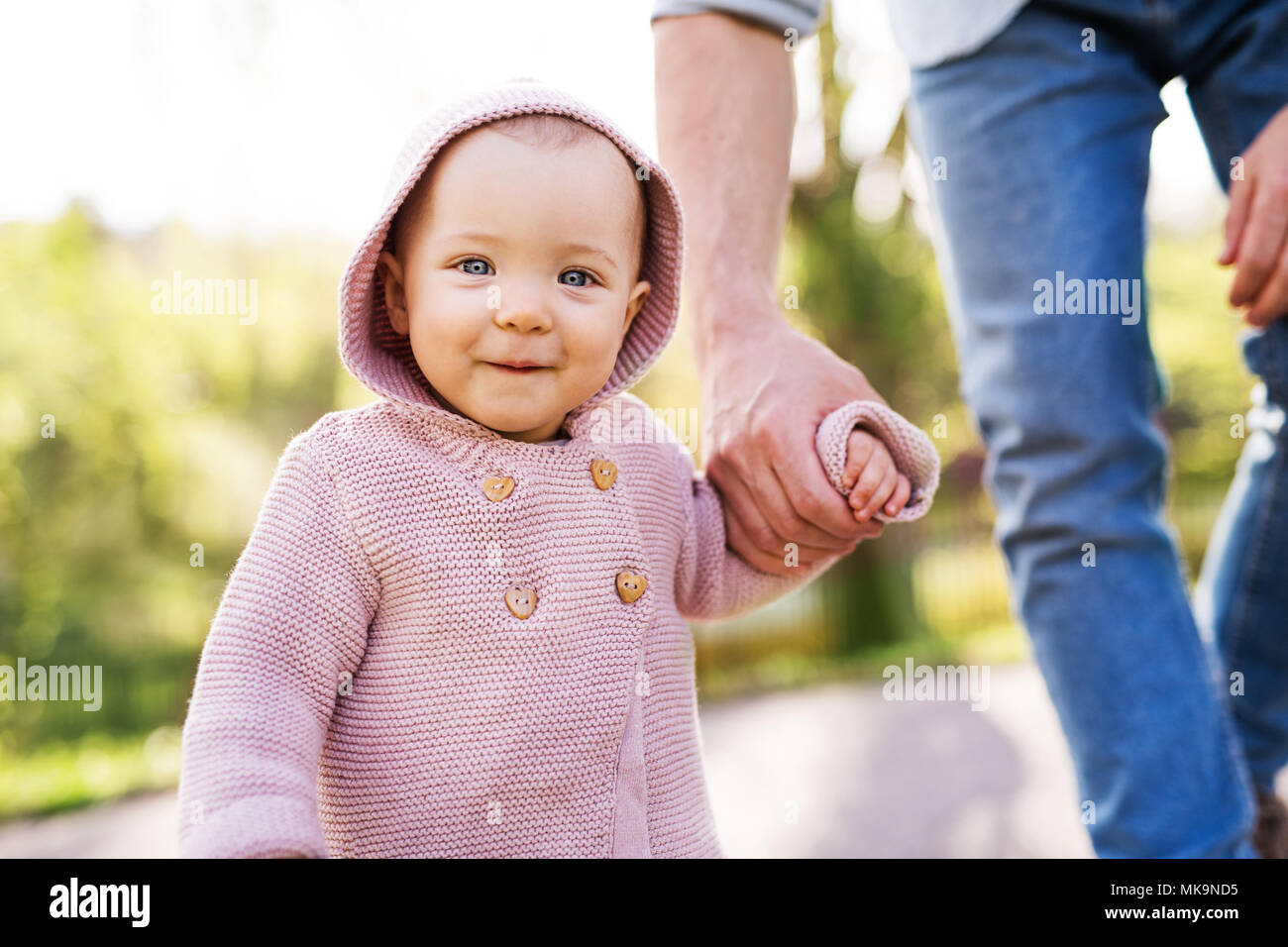 A father with his toddler daughter outside in spring nature. Stock Photo