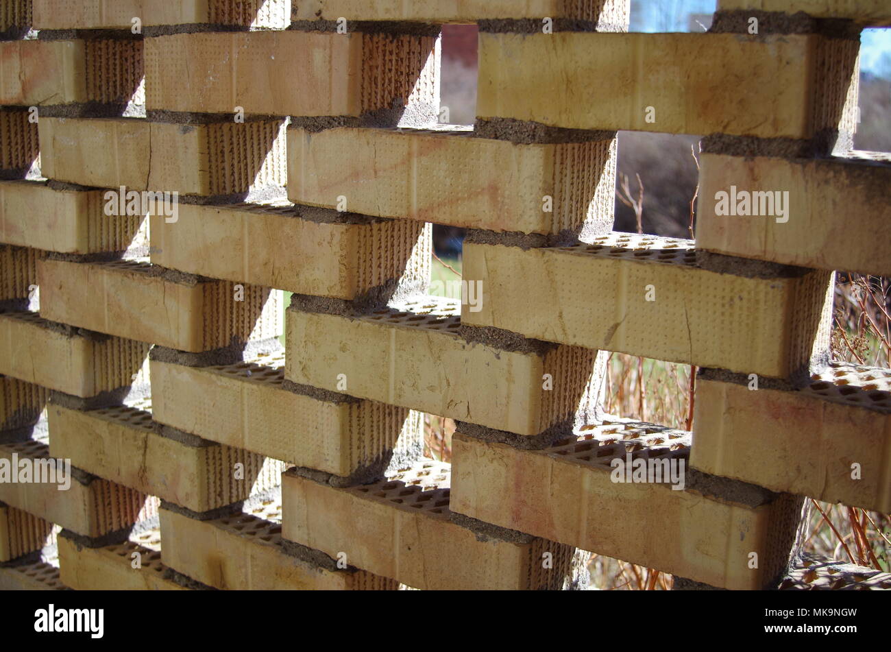 A brick wall with holes Stock Photo - Alamy