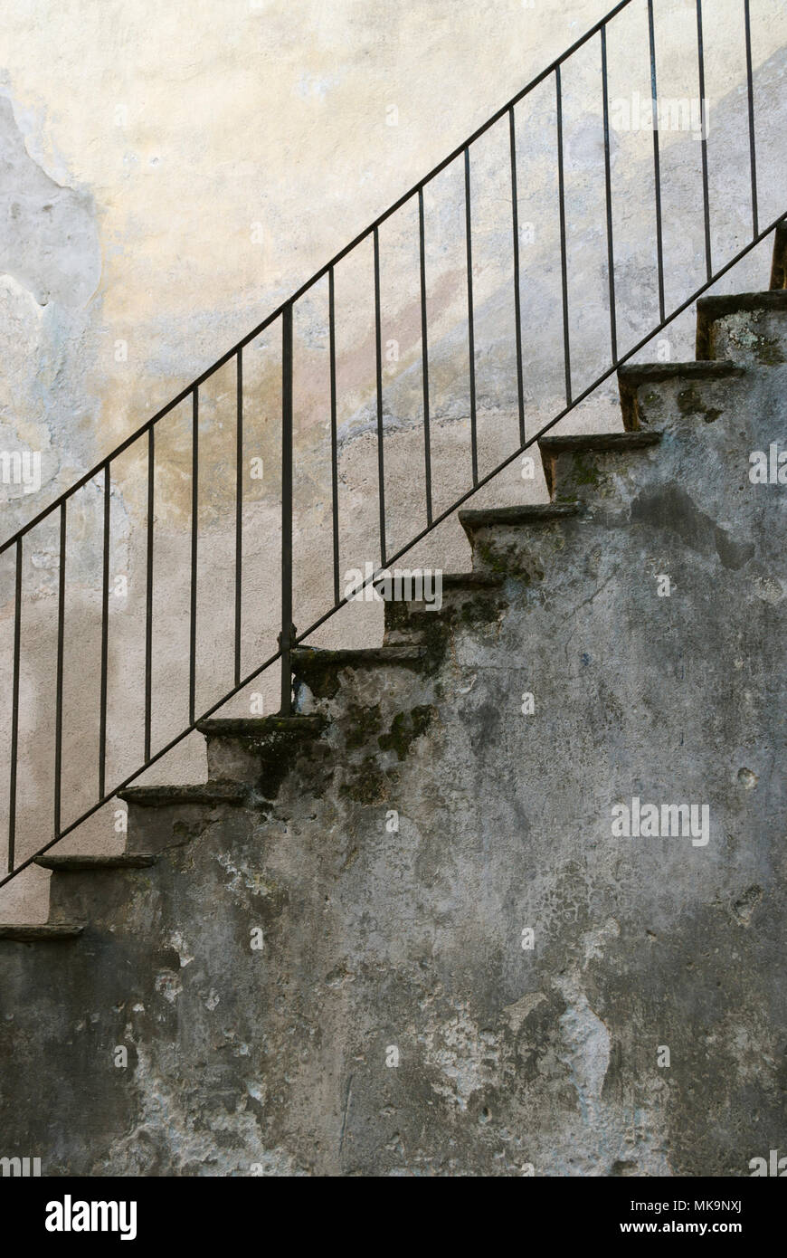 old exterior stone staircase with metal handrail Stock Photo