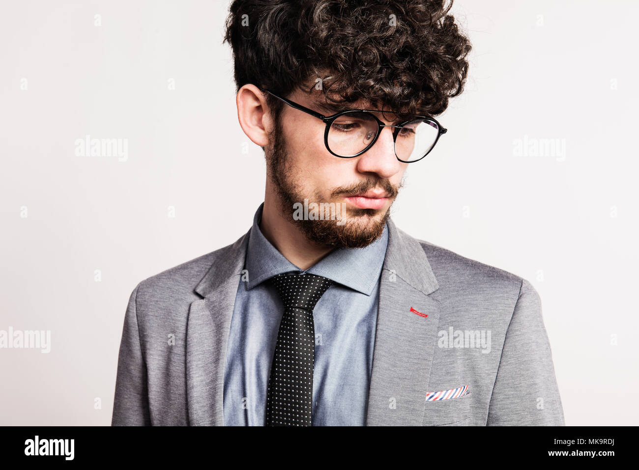 Portrait of a young man in gray suit in a studio Stock Photo - Alamy