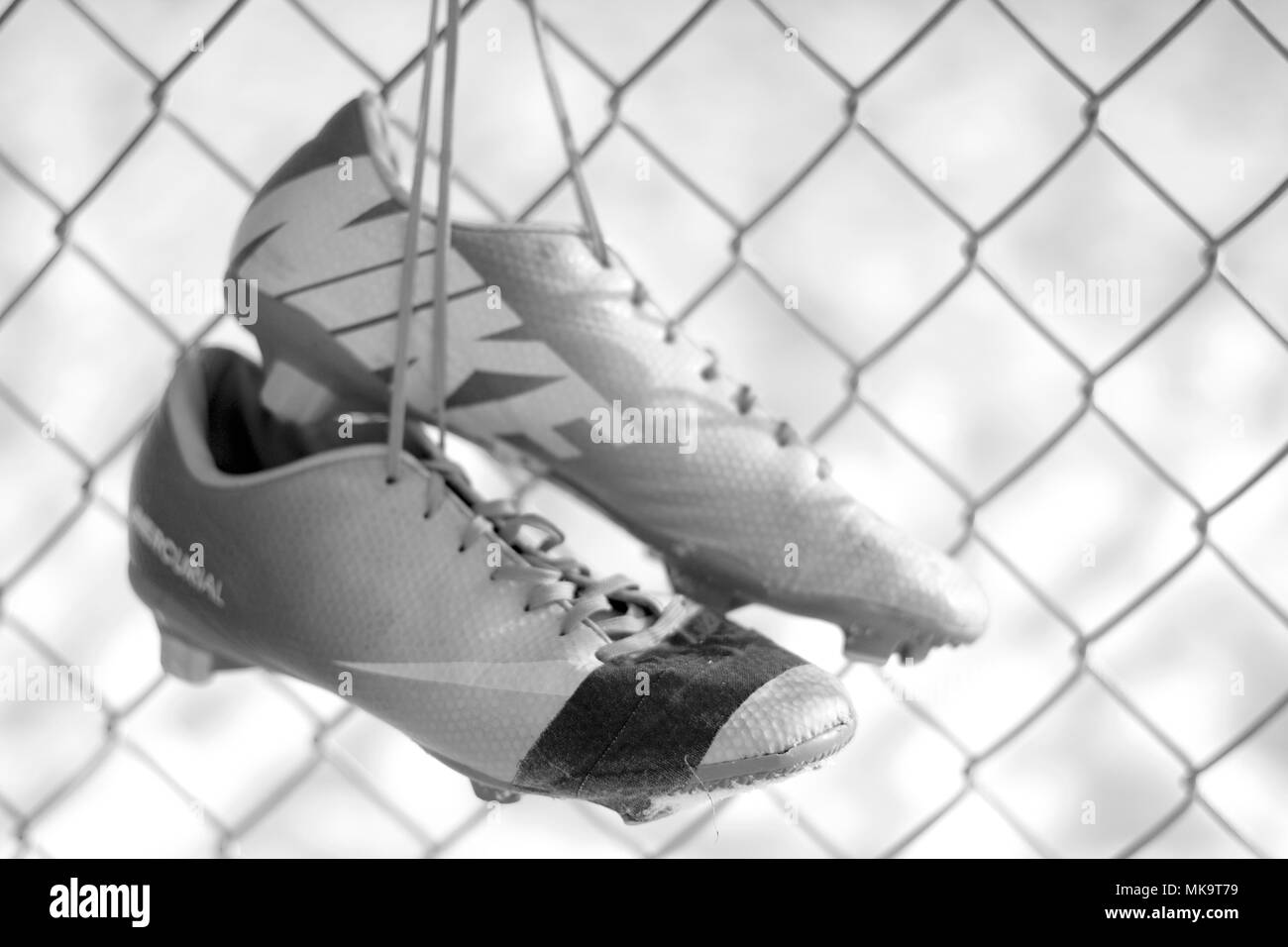 Yakima, Washington / USA - December 17, 2016:  Worn out and well loved soccer cleats displayed in an artistic photograph. Stock Photo