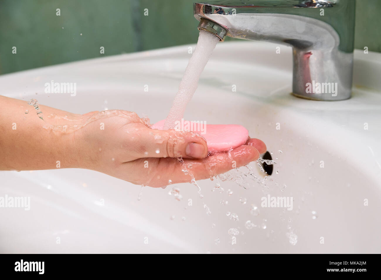Woman washing hands with soap in sink Stock Photo - Alamy