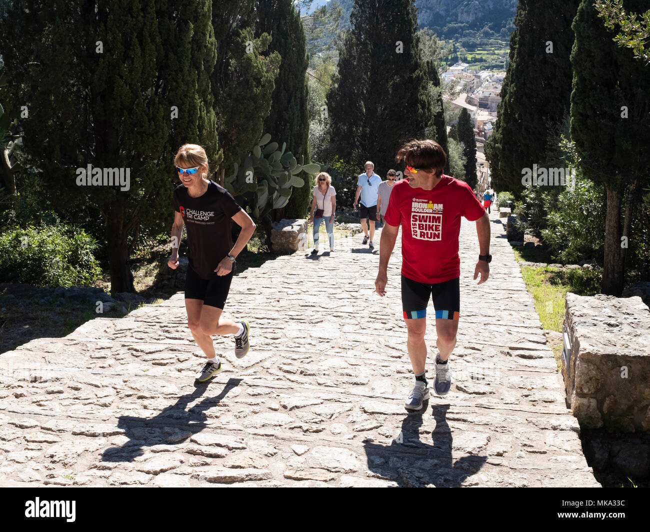 A man and a woman run up the 365 Calvary Steps in Pollensa town, Mallorca, Spain. Stock Photo