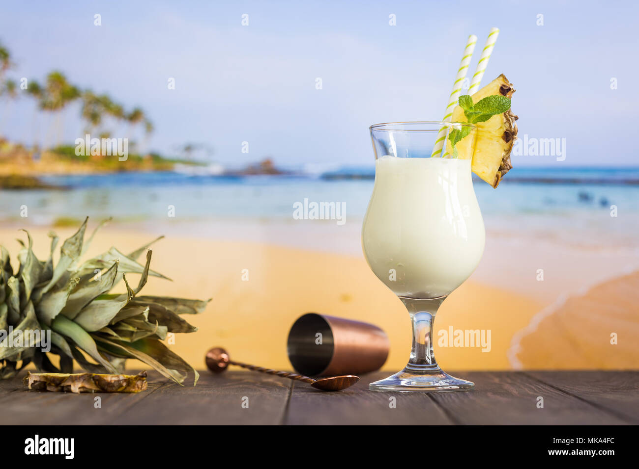 Cold pina colada cocktail in a glass on the beach with seascape ...