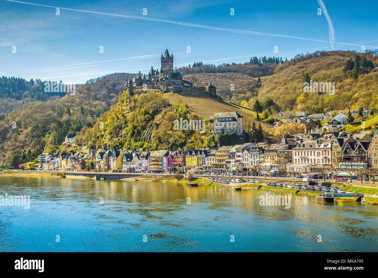 Beautiful view of the historic town of Cochem with famous Reichsburg castle on top of a hill and scenic Moselle river on a sunny day with blue sky and Stock Photo