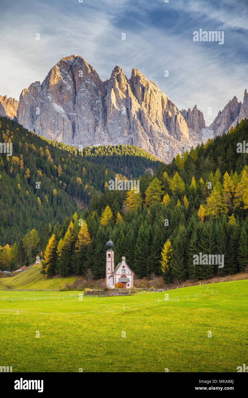 Beautiful view of historic Church of St. Johann of Nepomuk with famous Odle Group mountain peaks in the Dolomites in beautiful evening light at sunset Stock Photo
