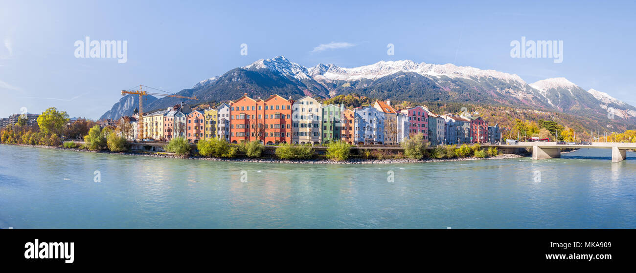 Panoramic view of the historic city center of Innsbruck with colorful houses along Inn river and famous Austrian mountain summits in the background in Stock Photo