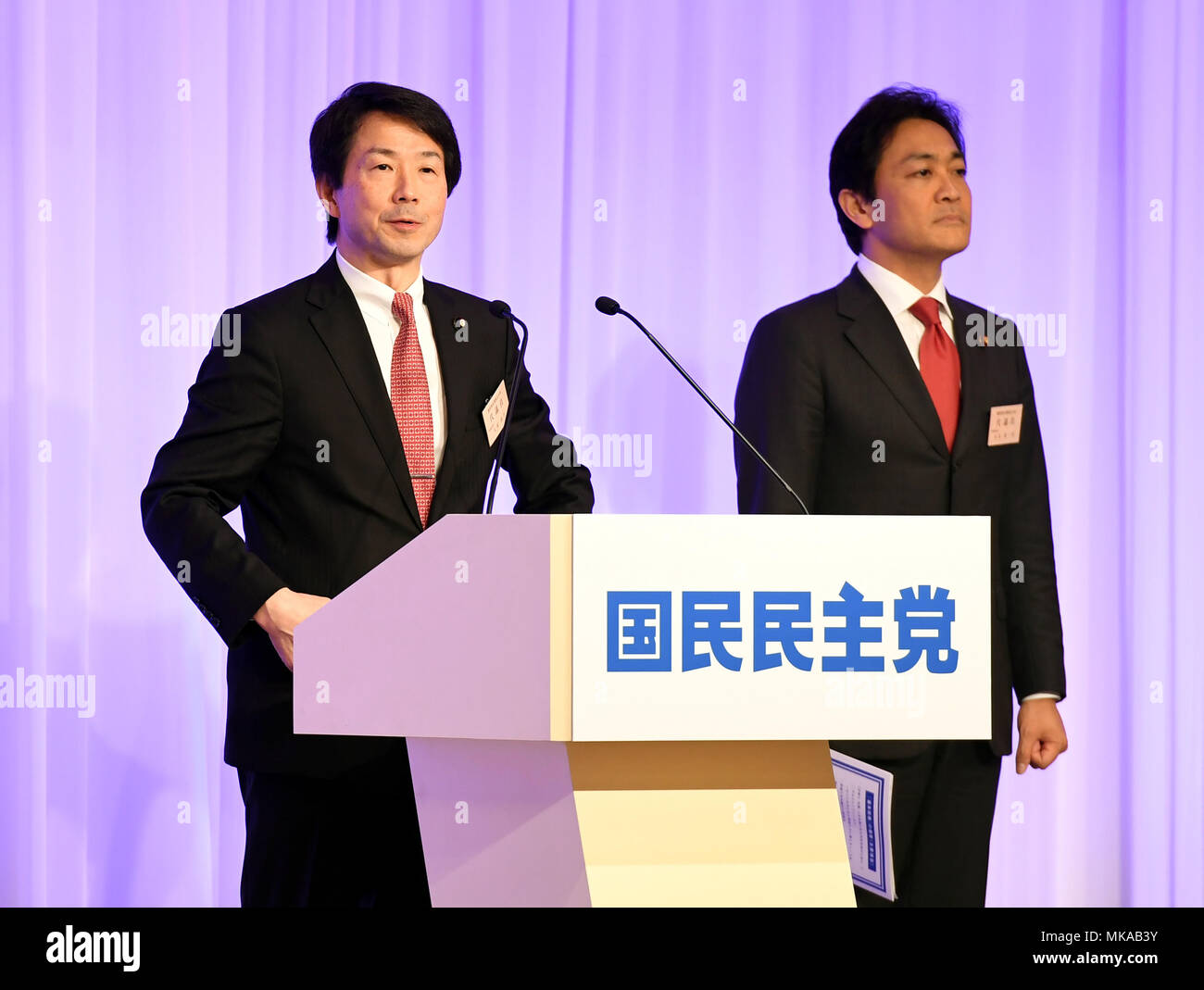Tokyo, Japan. 7th May, 2018. Kohei Otsuka (L), an upper house lawmaker who led the Democratic Party, speaks during the new party's inauguration ceremony in Tokyo, Japan, May 7, 2018. The now-obsolete opposition Democratic Party of Japan and the Party of Hope joined forces again Monday under the new single party name Democratic Party for the People. Credit: Ma Ping/Xinhua/Alamy Live News Stock Photo