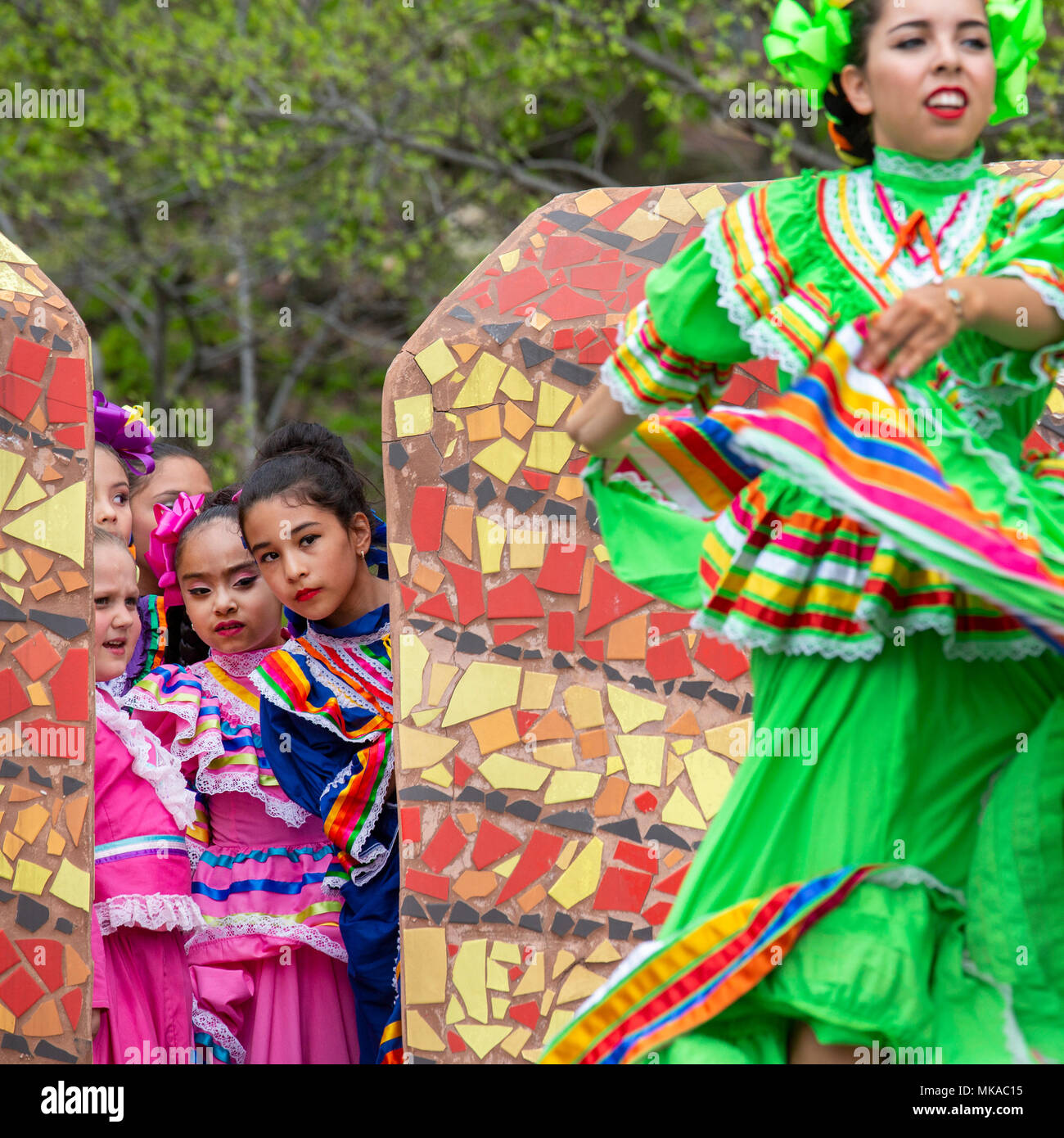 Detroit, Michigan USA - 6 May 2018 - Young Mexican dancers watch as an older dancer performs during Detroit's Cinco de Mayo celebration. Credit: Jim West/Alamy Live News Stock Photo
