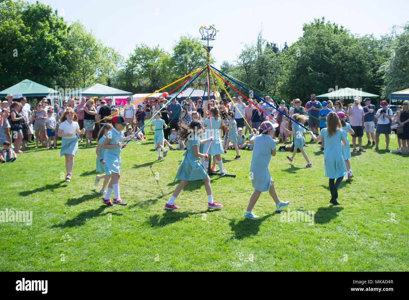 Ascot, UK - School children dance around the May Pole at Winkfield May Fair, Ascot Credit: Andrew Spiers/Alamy Live News Stock Photo