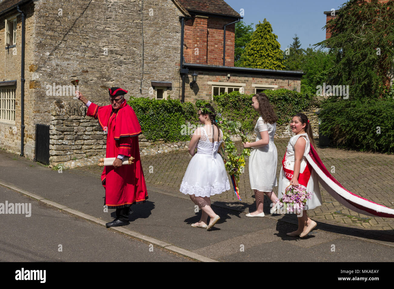 Quinton, Northamptonshire, UK 7th May 2018. Following a procession from the village hall led by a Town Crier/Bellman, this year's May Queen Samantha Childs, was crowned at a ceremony on the village green. The village has records of this event going back some 60 years. Credit: David Humphreys/Alamy Live News Stock Photo