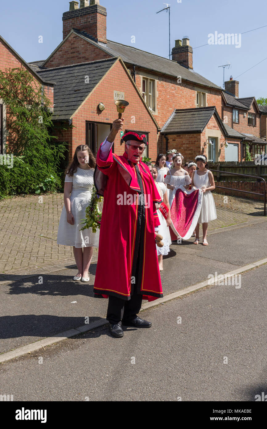 Quinton, Northamptonshire, UK 7th May 2018. Following a procession from the village hall led by a Town Crier/Bellman, this year's May Queen Samantha Childs, was crowned at a ceremony on the village green. The village has records of this event going back some 60 years. Credit: David Humphreys/Alamy Live News Stock Photo