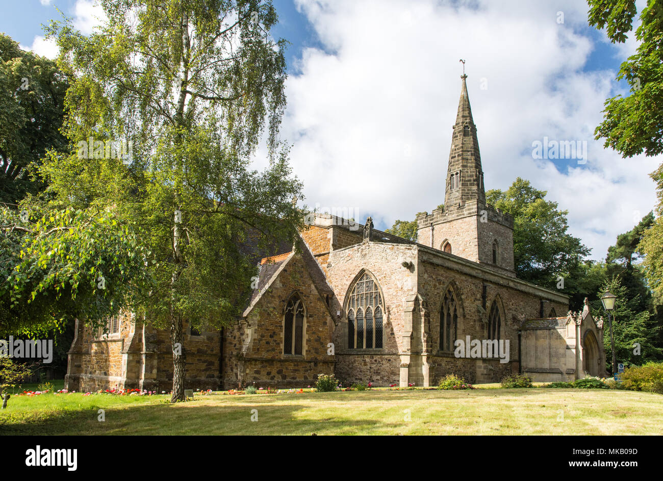 Leicester, England, UK - September 5, 2017: Sun shines on the traditional parish church and spire of St Denys in Evington in Leicester. Stock Photo