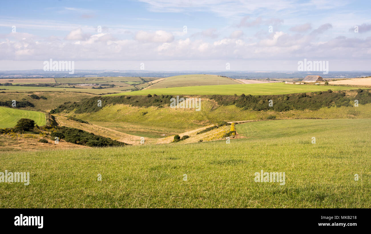A traditional farm barn stands on Chaldon Down in the rolling landscape of the Purbeck Hills in south Dorset, England. Stock Photo