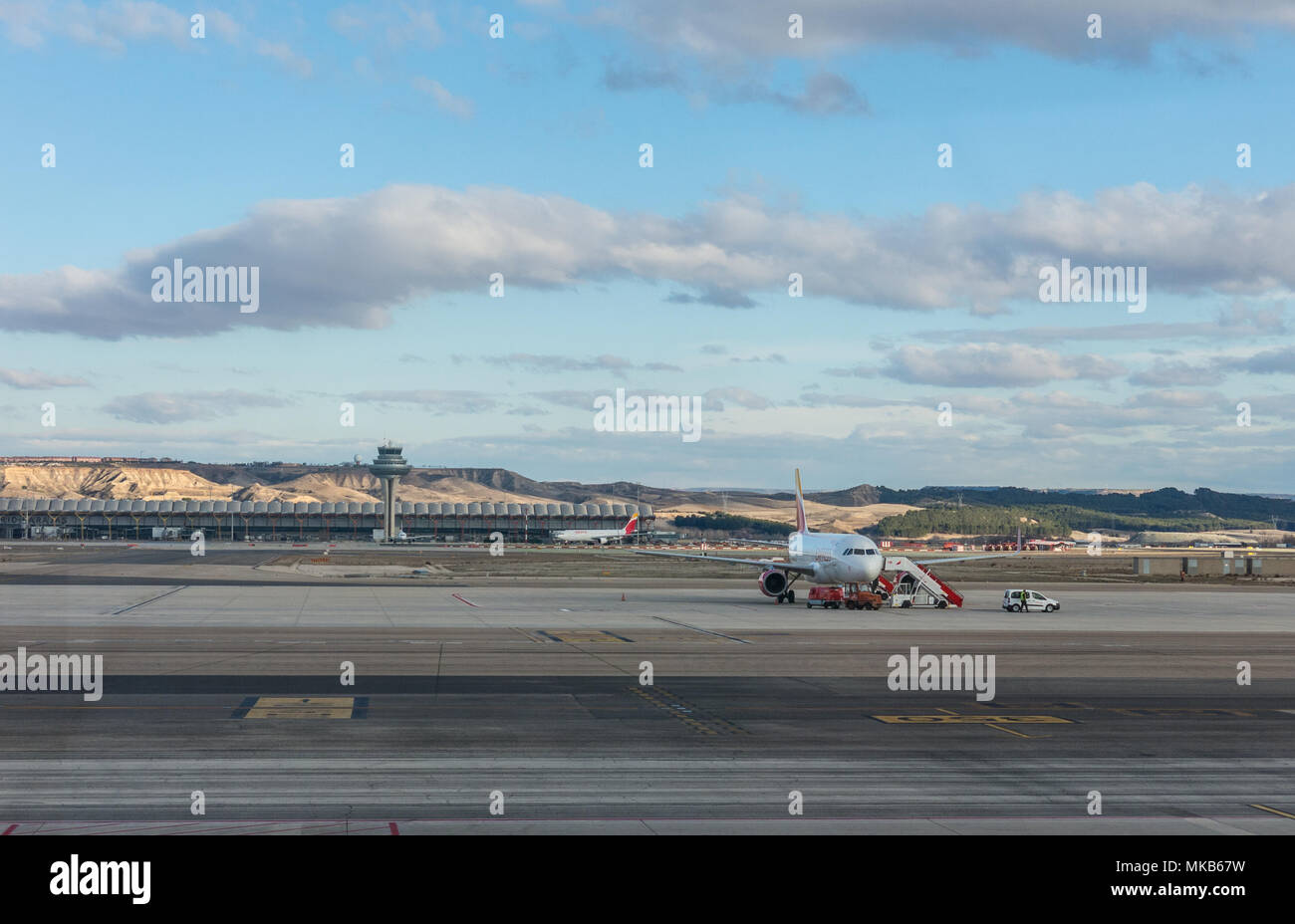 A plane prepares to take off on the runway of Terminal T4 the Adolfo Suarez Madrid Barajas Airport. Barajas is the main international airport in Madri Stock Photo