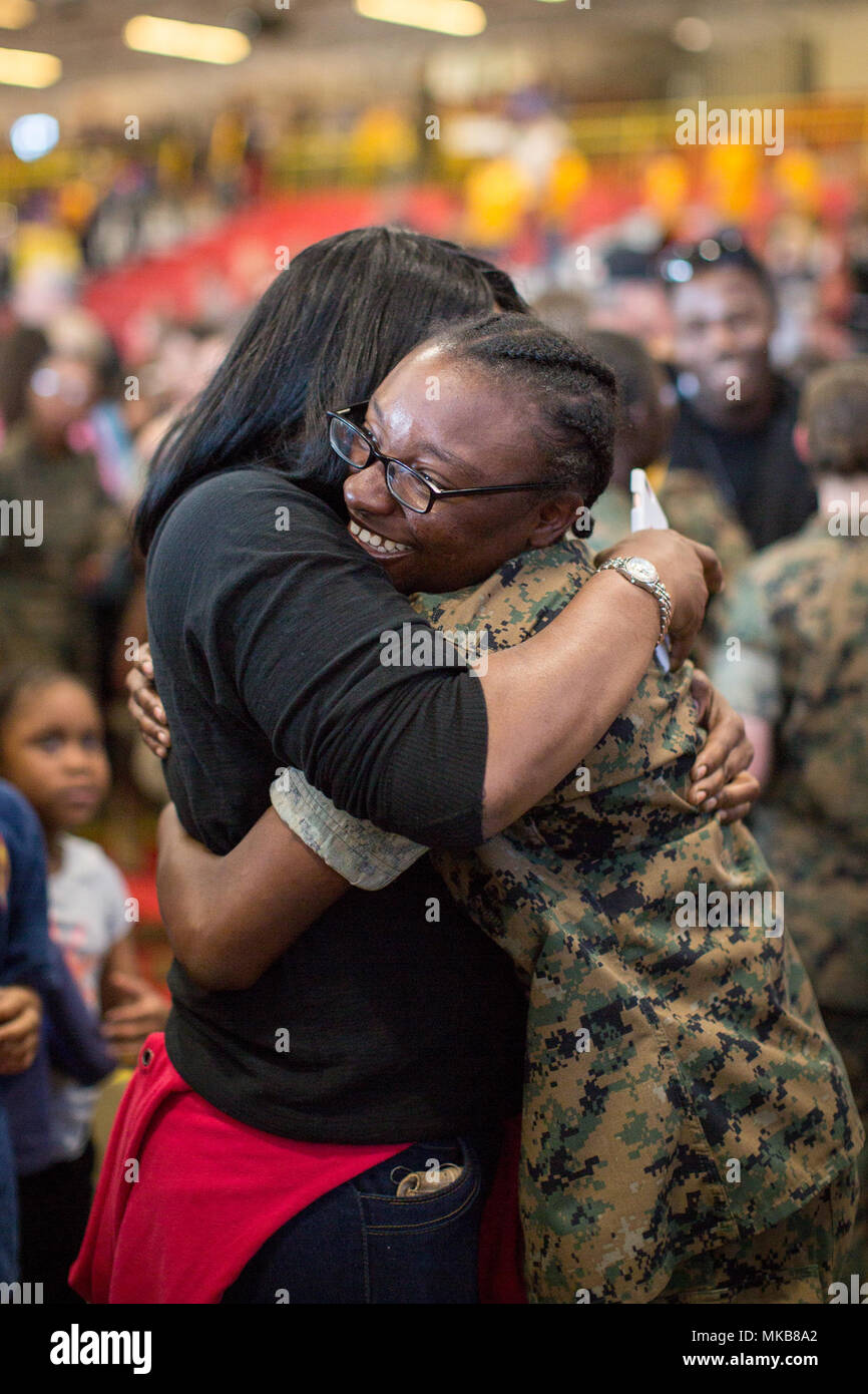 Pvt. Doresha L. Blackwell, from Richmond, Va., greets her mother for the first time after earning the title U.S. Marine. Having endured 12 weeks of arduous training, Marines with Hotel Company, 2nd Recruit Training Battalion, and Oscar Company, 4th Recruit Training Battalion, spend liberty with their family and friends Nov. 2, 2017, on Parris Island, S.C. The day before their graduation and release from Parris Island, the new Marines are given liberty during Family Day. Both companies are scheduled to graduate Nov. 3, 2017. (U.S. Marine Corps photo by Cpl. Joseph Jacob) Stock Photo