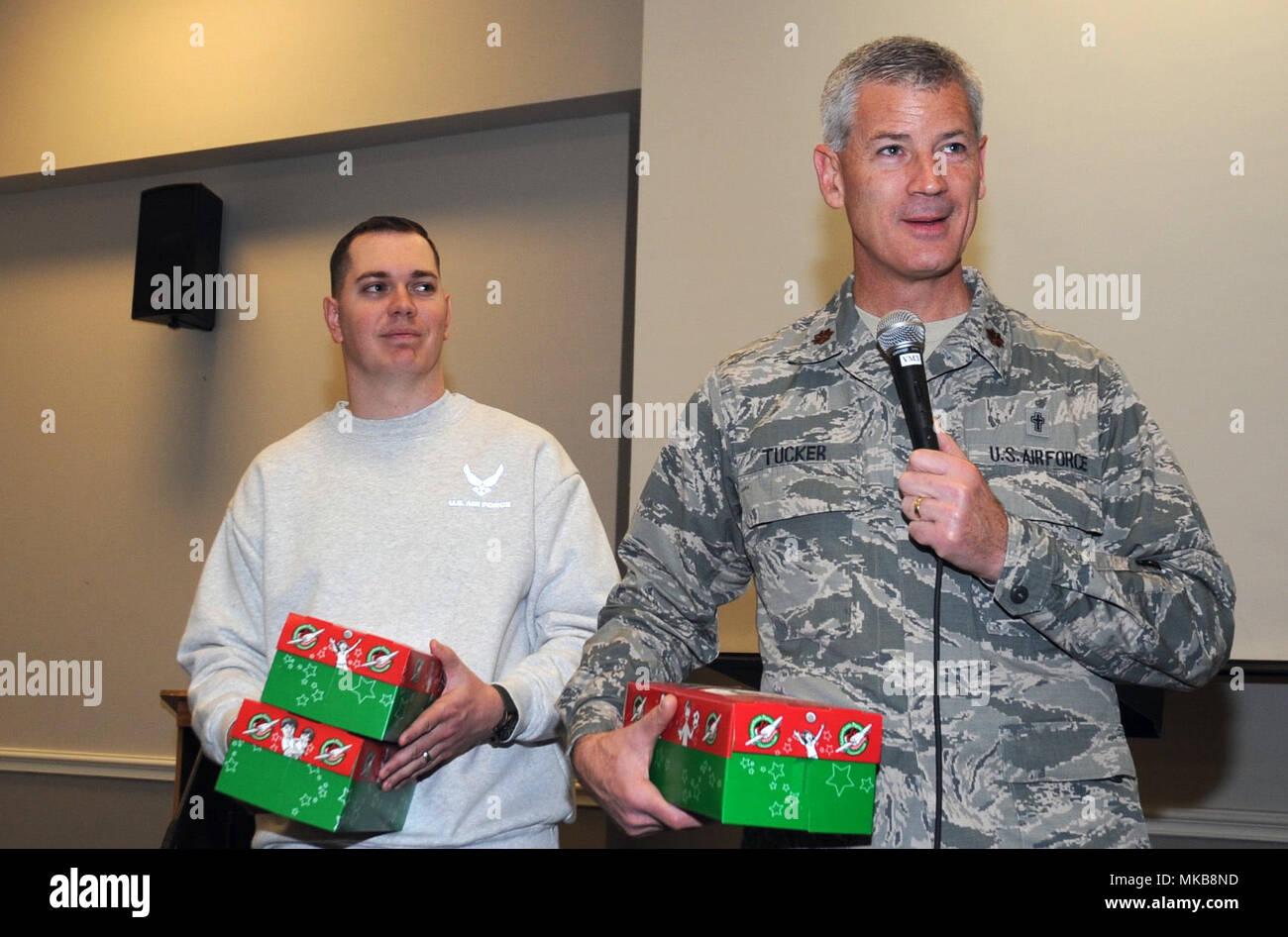 Maj. Nathan Tucker, a chaplain with the 136th Airlift Wing, thanks the morning chapel service attendees for contributions to Operation Christmas Child 2017 at Naval Air Station Fort Worth Joint Reserve Base in Fort Worth, TX, Nov. 19, 2017. Collaboratively, the wing filled more than 75 boxes clothes, school supplies, and toys to send a message of hope and love to children in more than 100 war-torn countries around the world. (Texas Air National Guard photo by Staff Sgt. Kristina Overton) Stock Photo