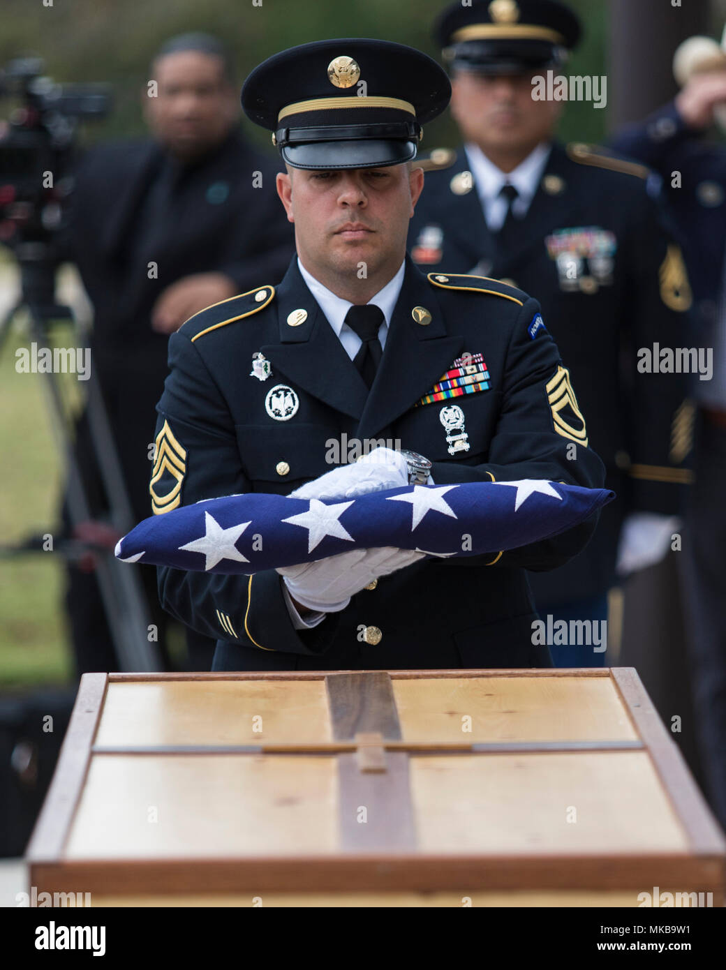 Honorary pallbearers fold the U.S. flag that was draped on Retired Gen. Richard E. Cavazos’ casket during his internment ceremony Nov. 14, 2017, at Joint Base San Antonio-Fort Sam Houston National Cemetery, Texas. In 1976 Mexican-American Cavazos made military history by becoming the first Hispanic to attain the rank of brigadier general in the U.S. Army. Less than 20 years later, the native Texan would again make history by being appointed the U.S. Army's first Hispanic four-star general. He had been retired since 1984 and died Oct. 29, 2017 after a long illness at 88. (U.S. Air Force photo b Stock Photo