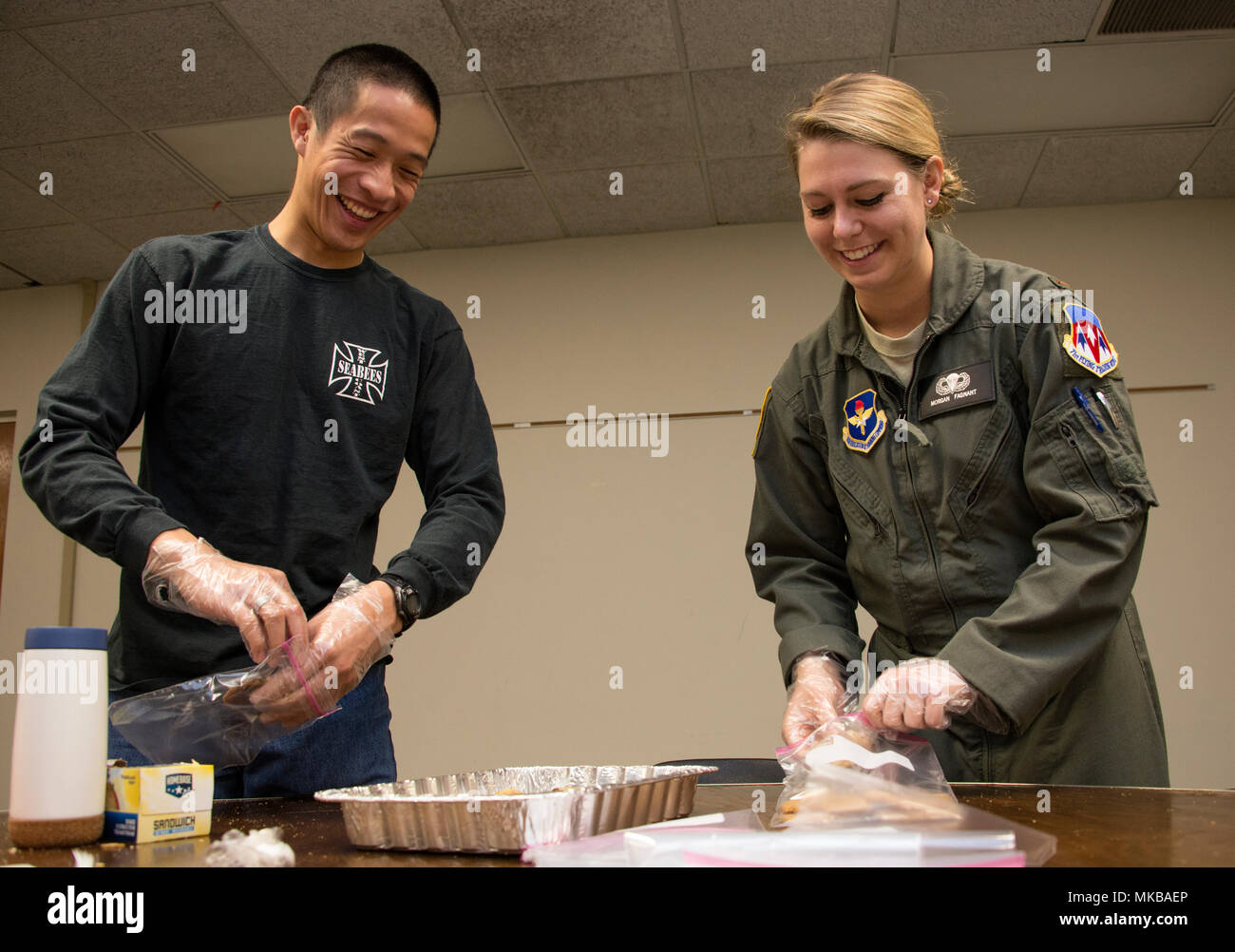 Members of Vance Air Force Base bag cookies for deployed Airmen, Nov. 9, 2017 at the Vance Community Chapel Activity Center. More than 20 deployed Vance Airmen recieved cookies during operation Cookie Cutter. Stock Photo